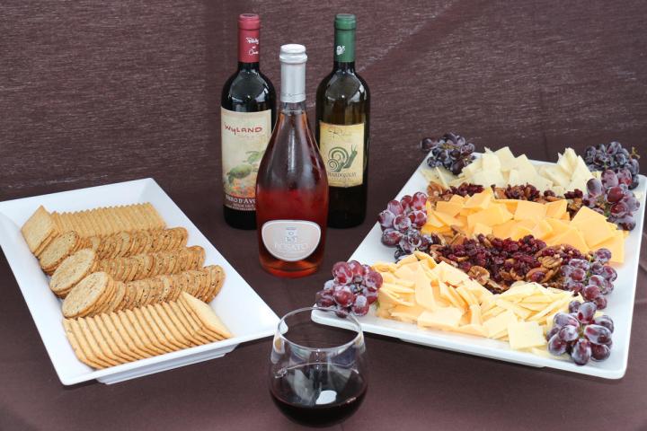 a plate of food and a bottle of wine on a table
