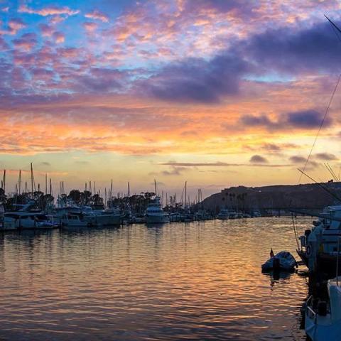 a boat is docked next to a body of water