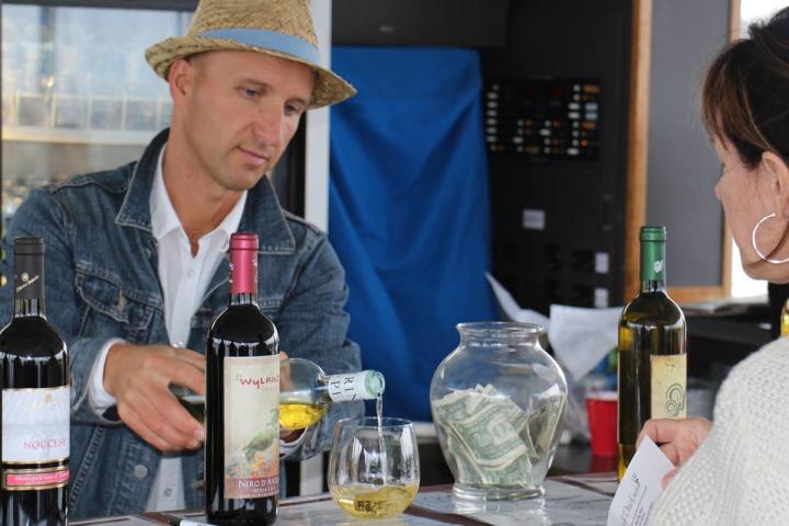 a person holding a bottle of wine