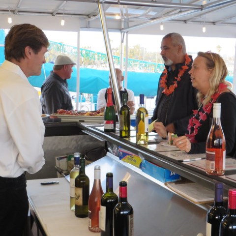 a group of people standing in a kitchen preparing food