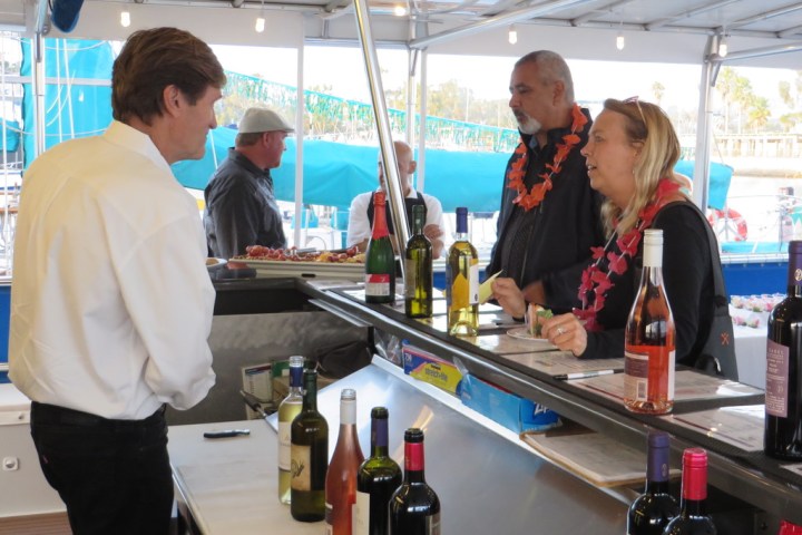a group of people standing in a kitchen preparing food
