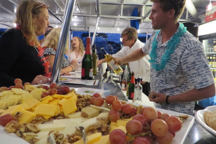 a group of people looking at a fruit stand